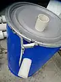 Metal popping seal with PVC entering at top and exiting on side