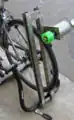 Pic 3: Slightly blurry image of generator unit attached to struts and mounted on the bike stand. Note that the friction wheel contacts bike wheel, but can be rotated away from lower pivot point, allowing bike to removed