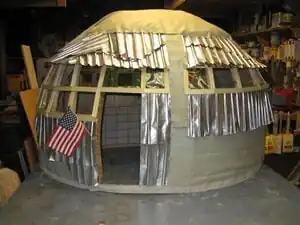 Aluminum Awareness Aluminum can shingles and 2-liter bottle windows.