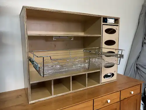 PPE cabinet with shelves, lights, sliding tray, and bottom compartments installed.