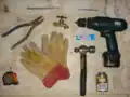 Drill, cement drill bit, PVC cement, 6" nail, silicone glue, hammer, pliers and wire cutter, tape measure, faucet and gloves.