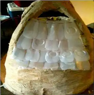 Plastic Plumage and Bird Cage Corrugated plastic shell and one gallon milk carton shingles.