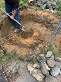 Image 3: After removing the liner, we began to dig out the layer of clay from the previous construction, in order to level the bottom of the pond and make it a bit deeper.